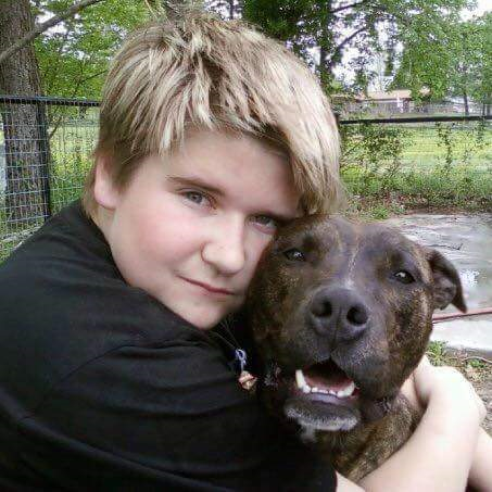 A photo of Caleb and his pitbull